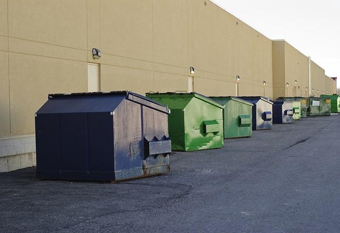 construction crew disposing of building materials in large bins in Branson